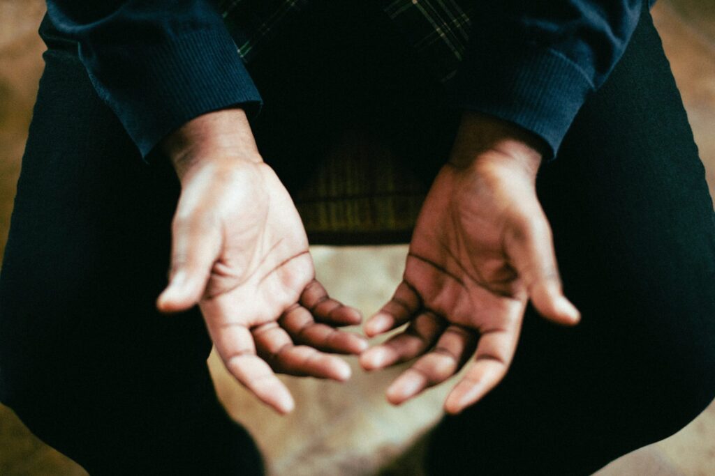 man praying with hands open