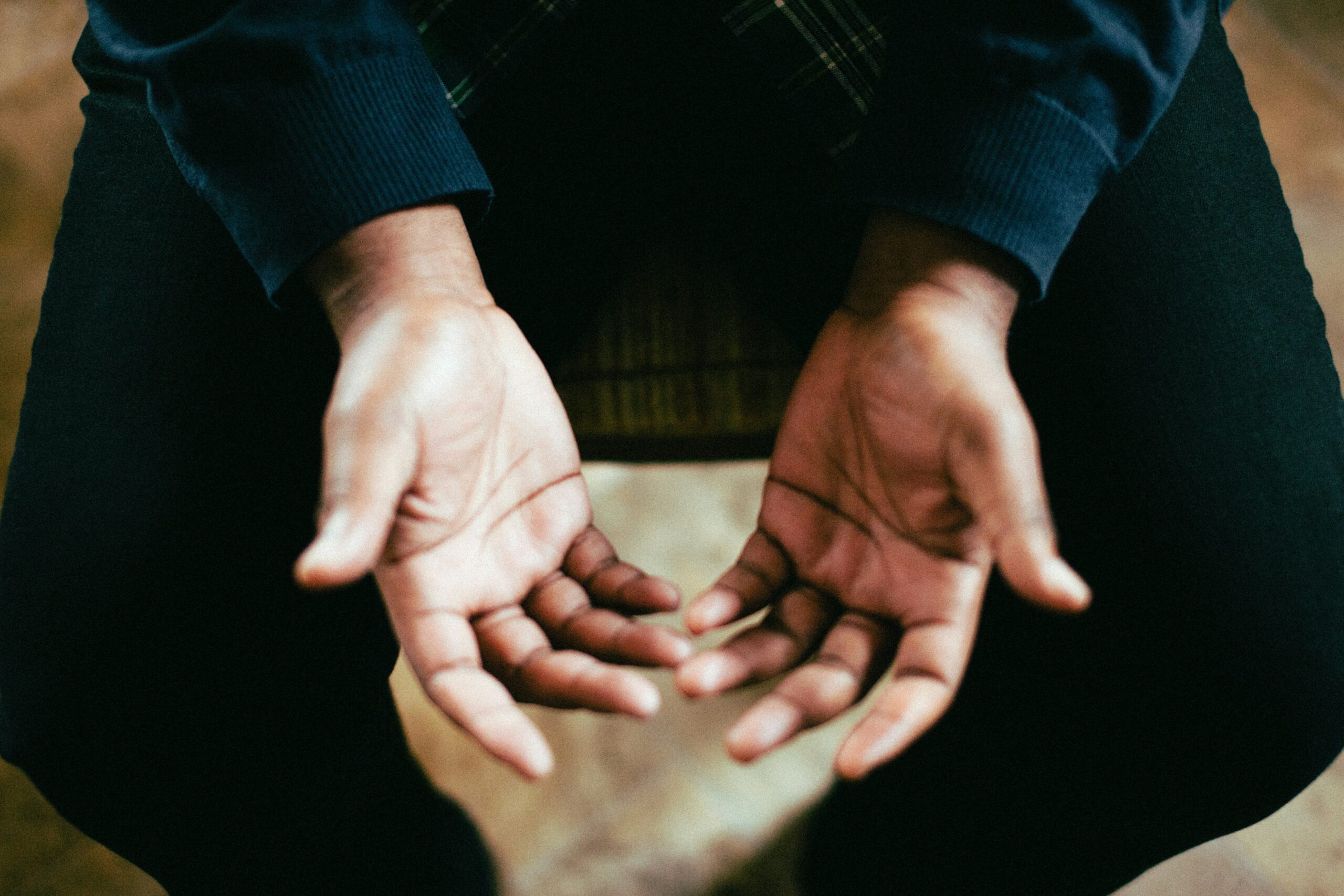 man praying with hands open